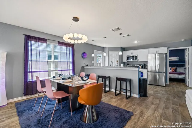 a view of a dining room with furniture window and wooden floor