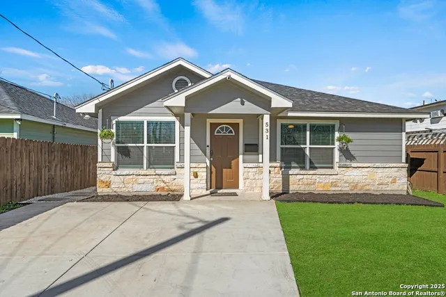 a view of a house with a yard and sitting area
