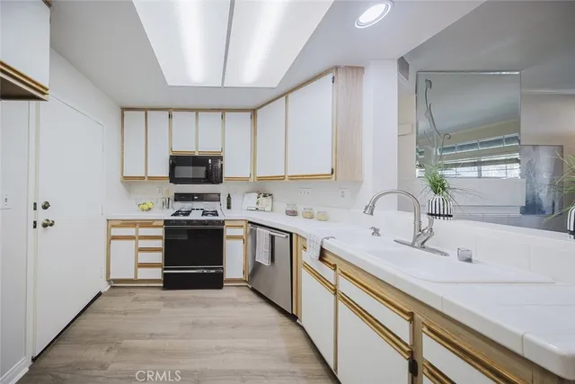 a kitchen with stainless steel appliances a stove sink and cabinets