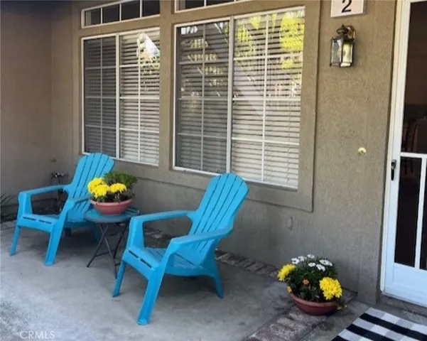 a front view of a house with outdoor seating and windows