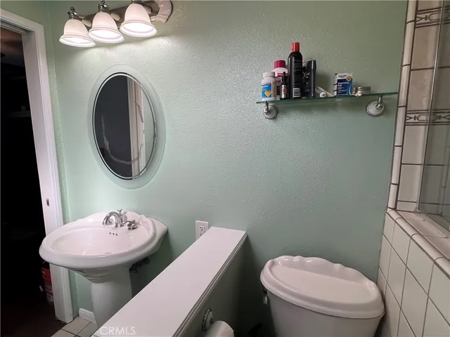 a bathroom with a toilet a sink and a mirror