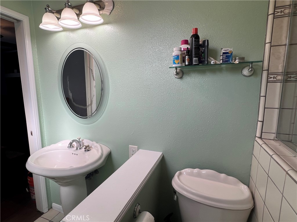 426 West 1st Street Azusa, CA 91702 - Photo 14 of 21 a bathroom with a toilet a sink and a mirror