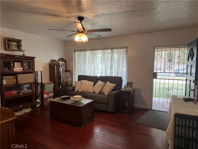 a living room with furniture a bookshelf and a window