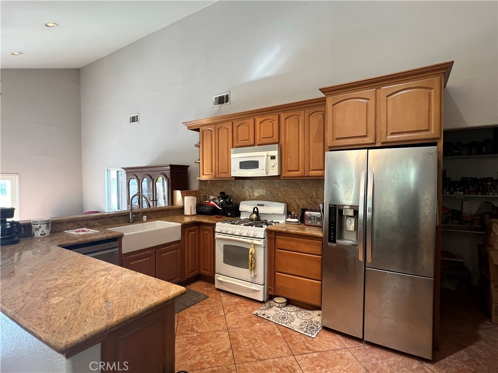 426 West 1st Street Azusa, CA 91702 - Photo 4 of 21 a kitchen with stainless steel appliances granite countertop a refrigerator stove top oven and sink