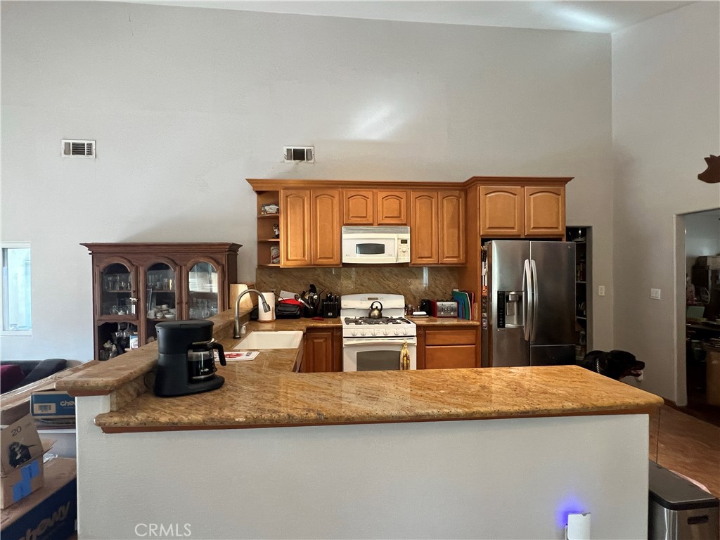 426 West 1st Street Azusa, CA 91702 - Photo 5 of 21 a kitchen with stainless steel appliances granite countertop a sink refrigerator and microwave
