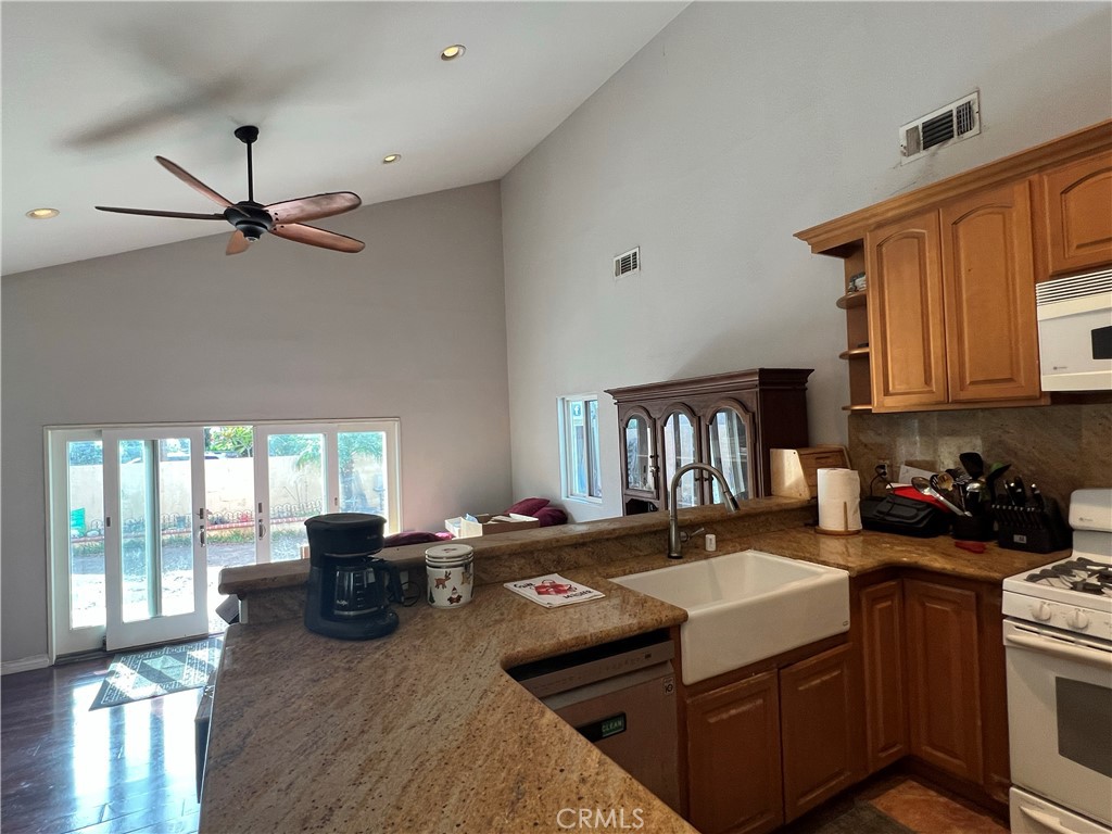 426 West 1st Street Azusa, CA 91702 - Photo 6 of 21 a kitchen with stainless steel appliances granite countertop a sink a stove and a refrigerator