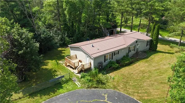 an aerial view of a house with a big yard