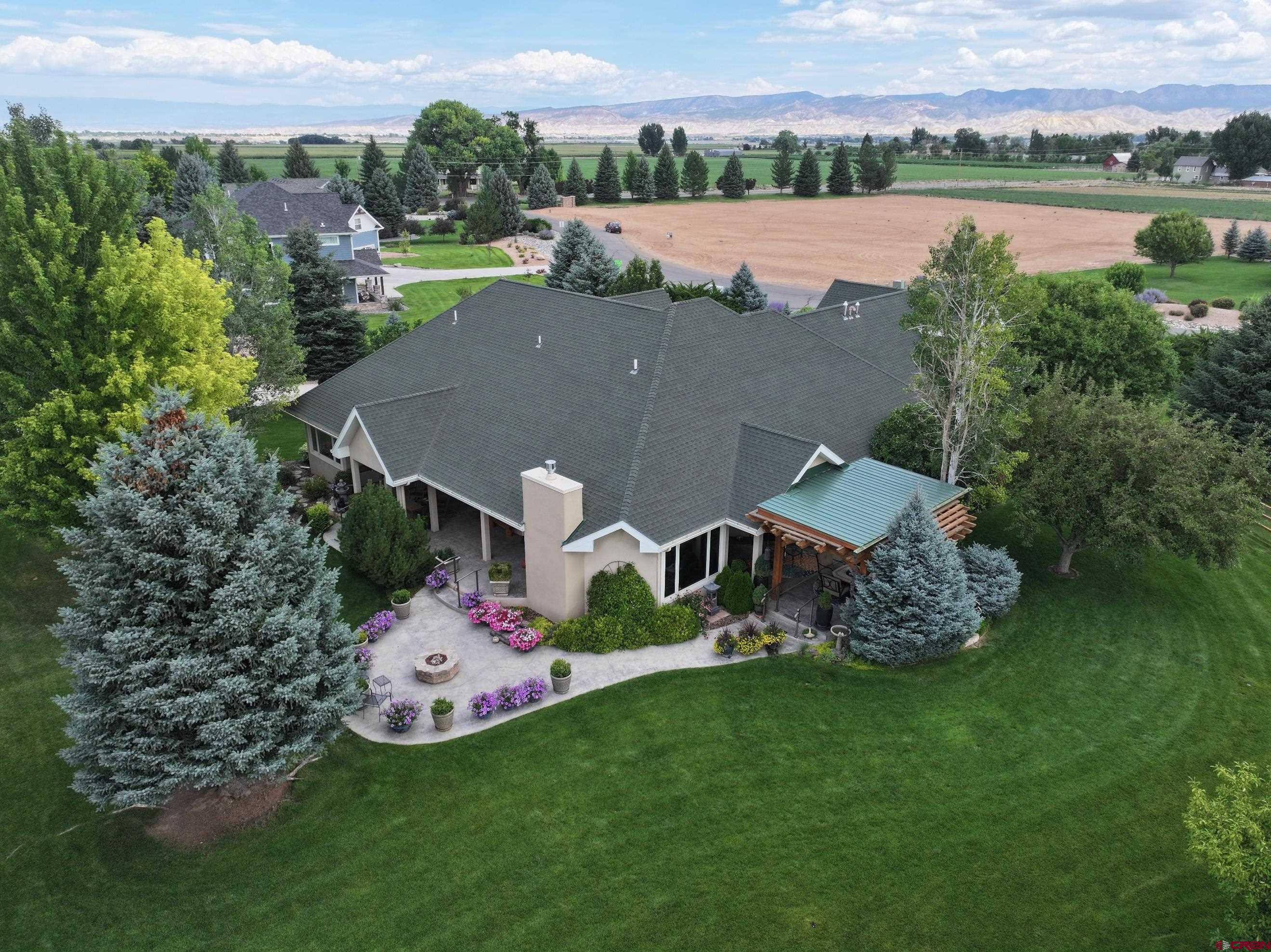 15103 6260th Road Montrose, CO 81403 - Photo 5 of 45 an aerial view of a house with outdoor space and lake view in back
