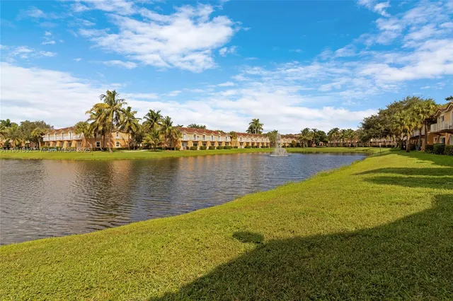 a view of a lake with houses in the back