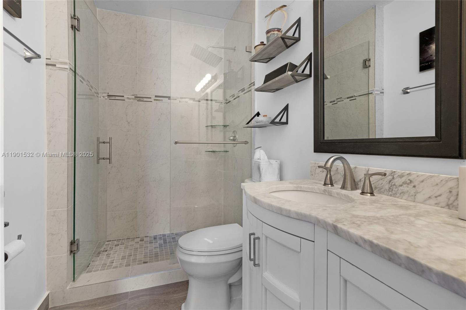 12905 Southwest 31st Court Miramar, FL 33027 - Photo 22 of 48 a bathroom with a granite countertop sink a toilet and shower