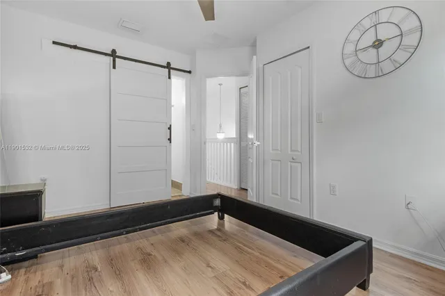 a view of an empty room with wooden floor