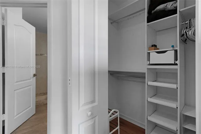 a view of walk in closet with empty racks