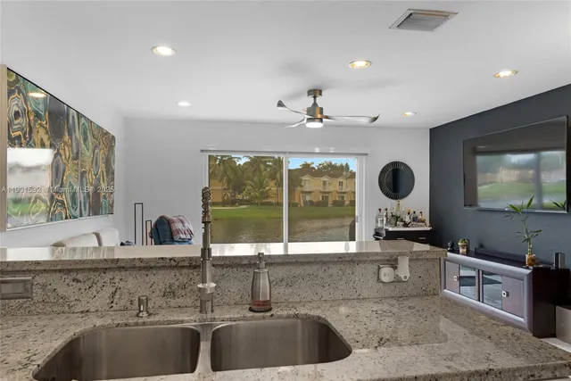 a kitchen with a sink and a large window