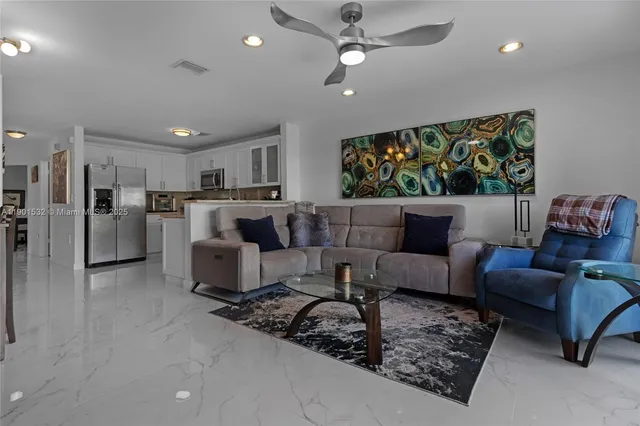 a living room with furniture and kitchen view