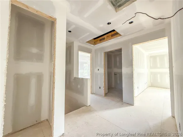a view of a walk in closet and a bathroom