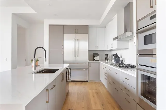 a kitchen with a sink stove and cabinets