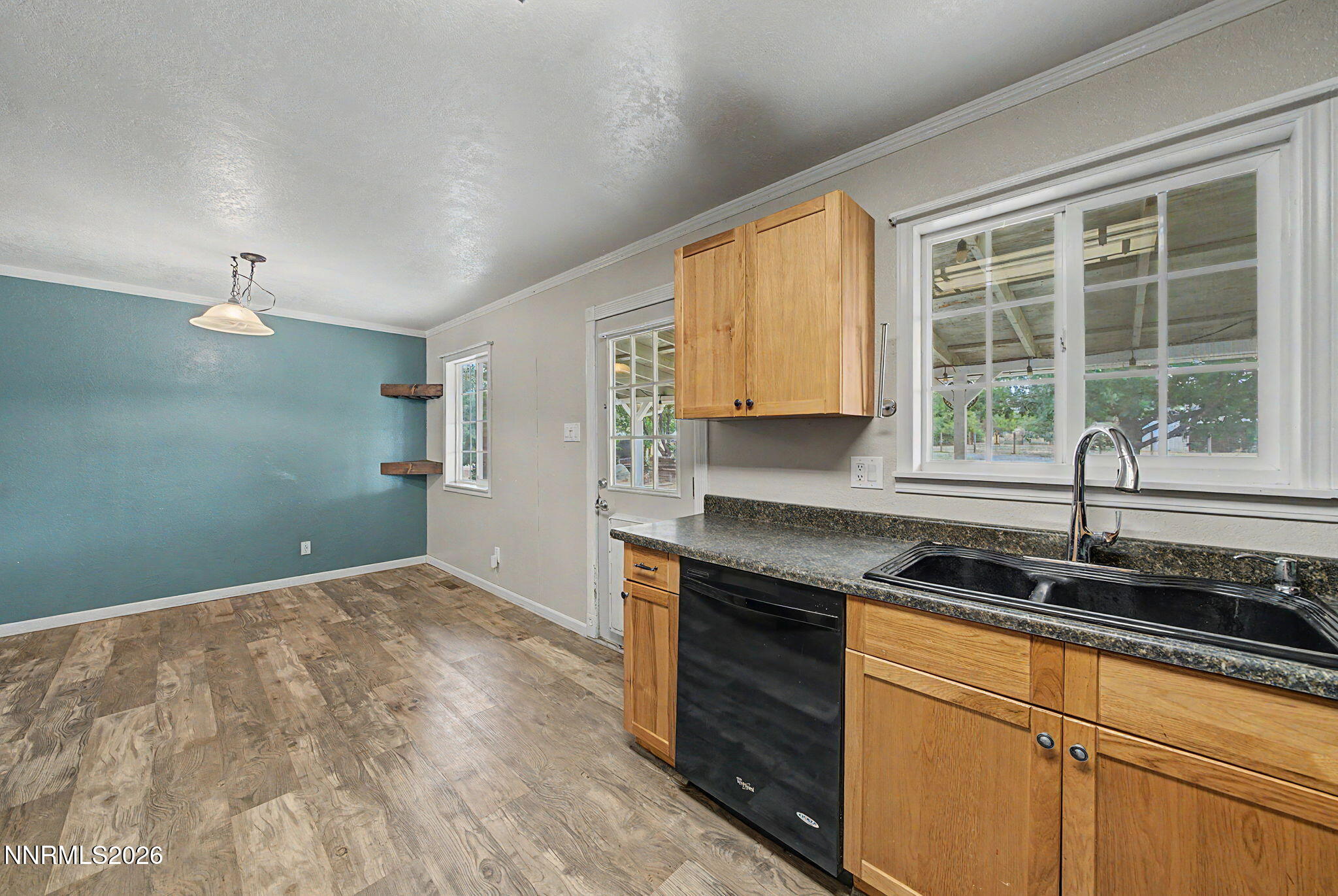 11577 Deodar Way Reno, NV 89506 - Photo 17 of 58 a kitchen with granite countertop cabinets stainless steel appliances a sink and a window