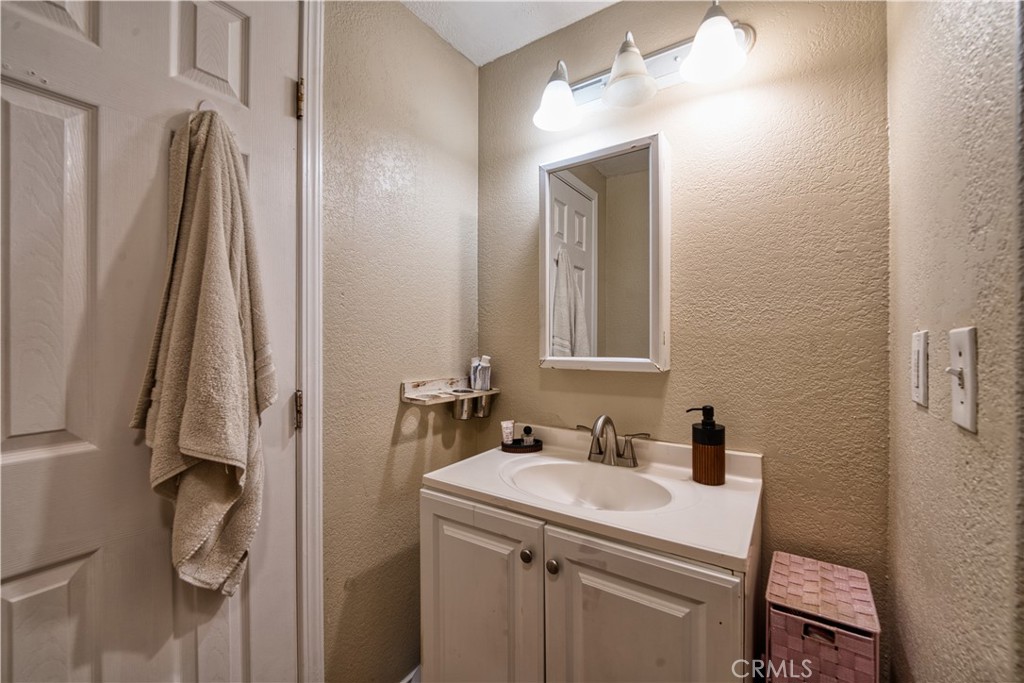 700 South Shafter, Unit 20 Shafter, CA 93263 - Photo 14 of 18 a bathroom with a sink a toilet and a mirror