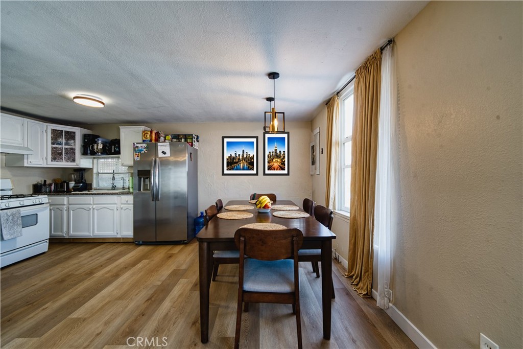 700 South Shafter, Unit 20 Shafter, CA 93263 - Photo 4 of 18 a kitchen with granite countertop stainless steel appliances a dining table and chairs