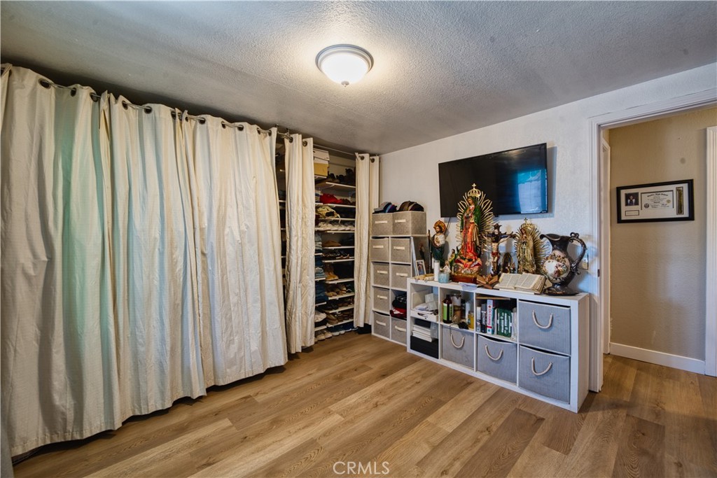 700 South Shafter, Unit 20 Shafter, CA 93263 - Photo 10 of 18 a room with furniture a flat screen tv and a wooden floor