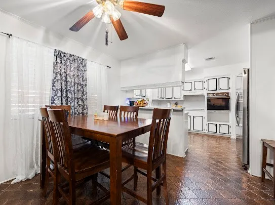 a dining room with furniture and wooden floor