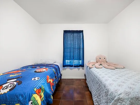 a bedroom with a bed and a painting on the wall