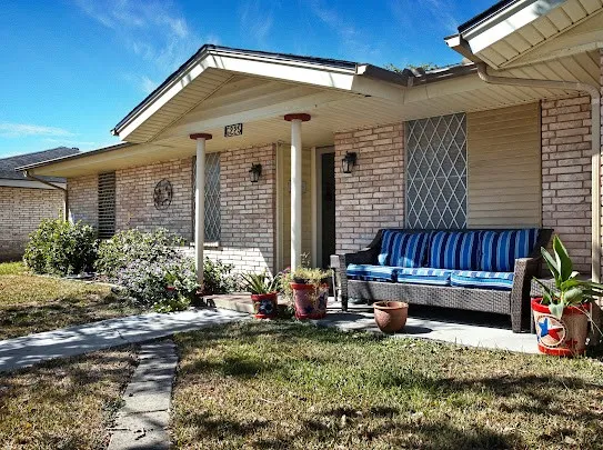 a view of a house with a yard and sitting area