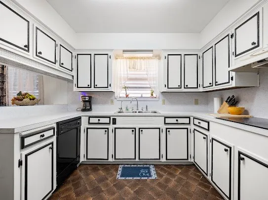 a kitchen with stainless steel appliances granite countertop a sink and cabinets