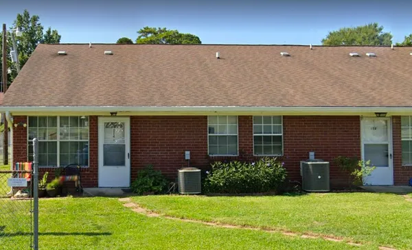 a view of a house with a yard and a garden