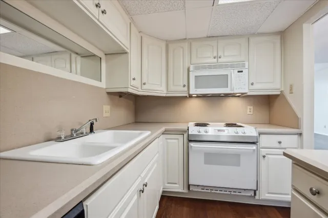 a view of cabinets a sink and dishwasher in a kitchen