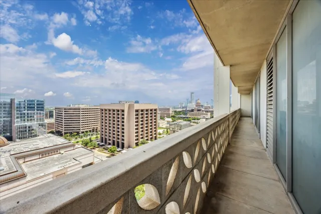 a view of balcony with wooden floor and fence