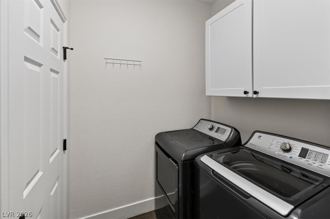 251 Integrity Ridge Drive Henderson, NV 89052 - Photo 21 of 32 White cabinetry and built-in storage optimize this functional laundry space.