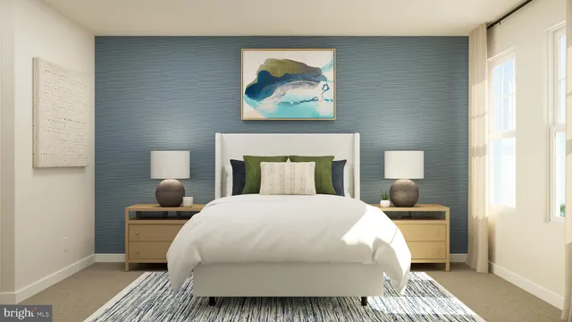 a bedroom with a bed and a painting on the wall