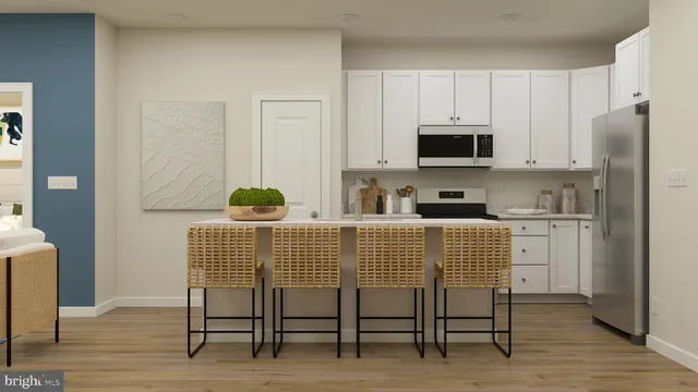 a kitchen with stainless steel appliances granite countertop a white cabinets and a stove top oven