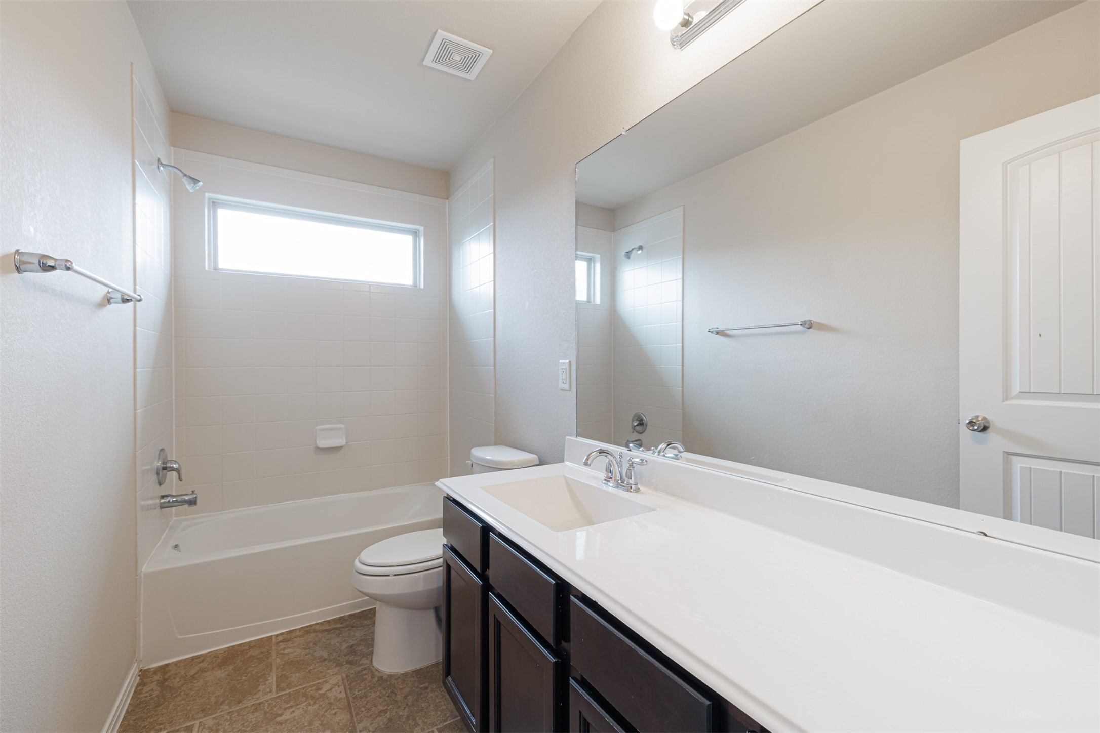 25322 Saddlebrook Ranch Drive Tomball, TX 77375 - Photo 16 of 20 a bathroom with a granite countertop sink toilet a large mirror a bathtub and shower