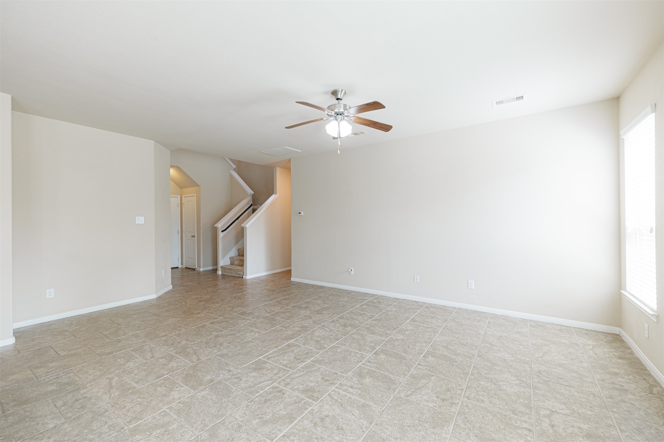 25322 Saddlebrook Ranch Drive Tomball, TX 77375 - Photo 8 of 20 an empty room with a ceiling fan and a window