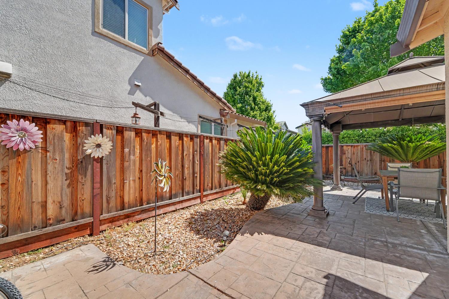 1223 East Springer Drive Turlock, CA 95382 - Photo 46 of 48 a backyard of a house with table and chairs couches with wooden fence