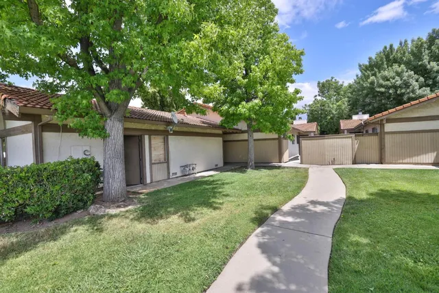 a view of a house with a yard and plants