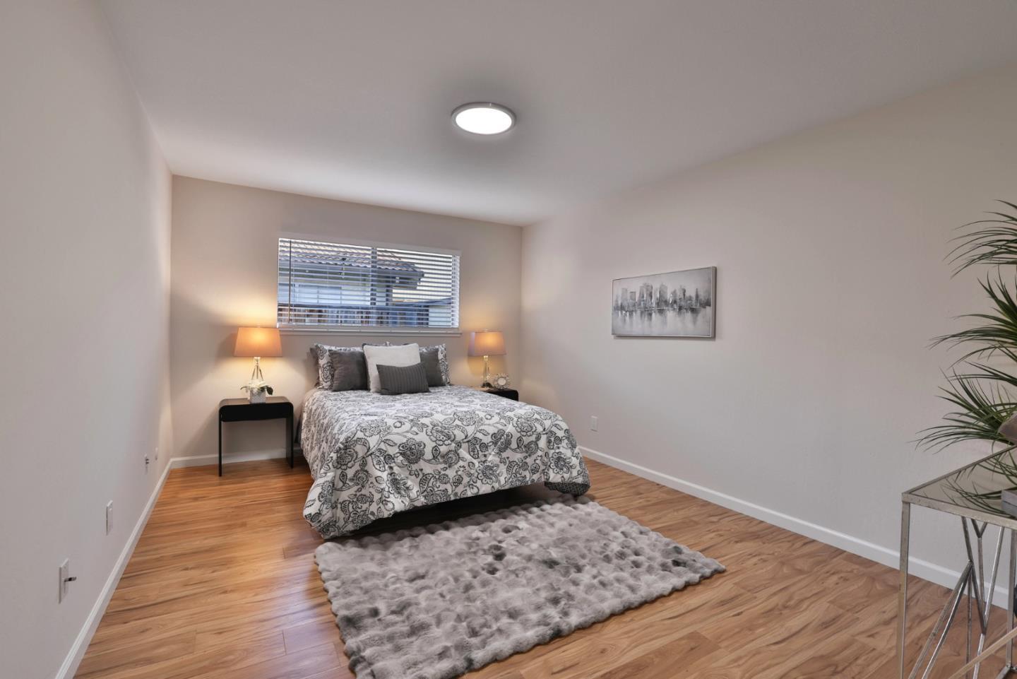 4648 Cherry Avenue San Jose, CA 95118 - Photo 11 of 29 a bedroom with a bed and a lamp on table