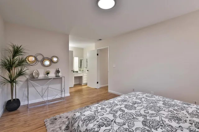 a bedroom with a bed and a potted plant