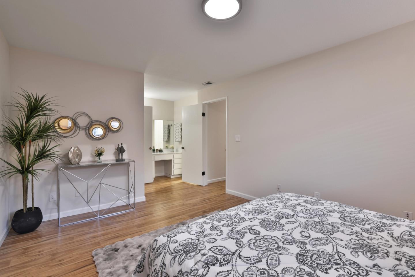 4648 Cherry Avenue San Jose, CA 95118 - Photo 12 of 29 a bedroom with a bed and a potted plant