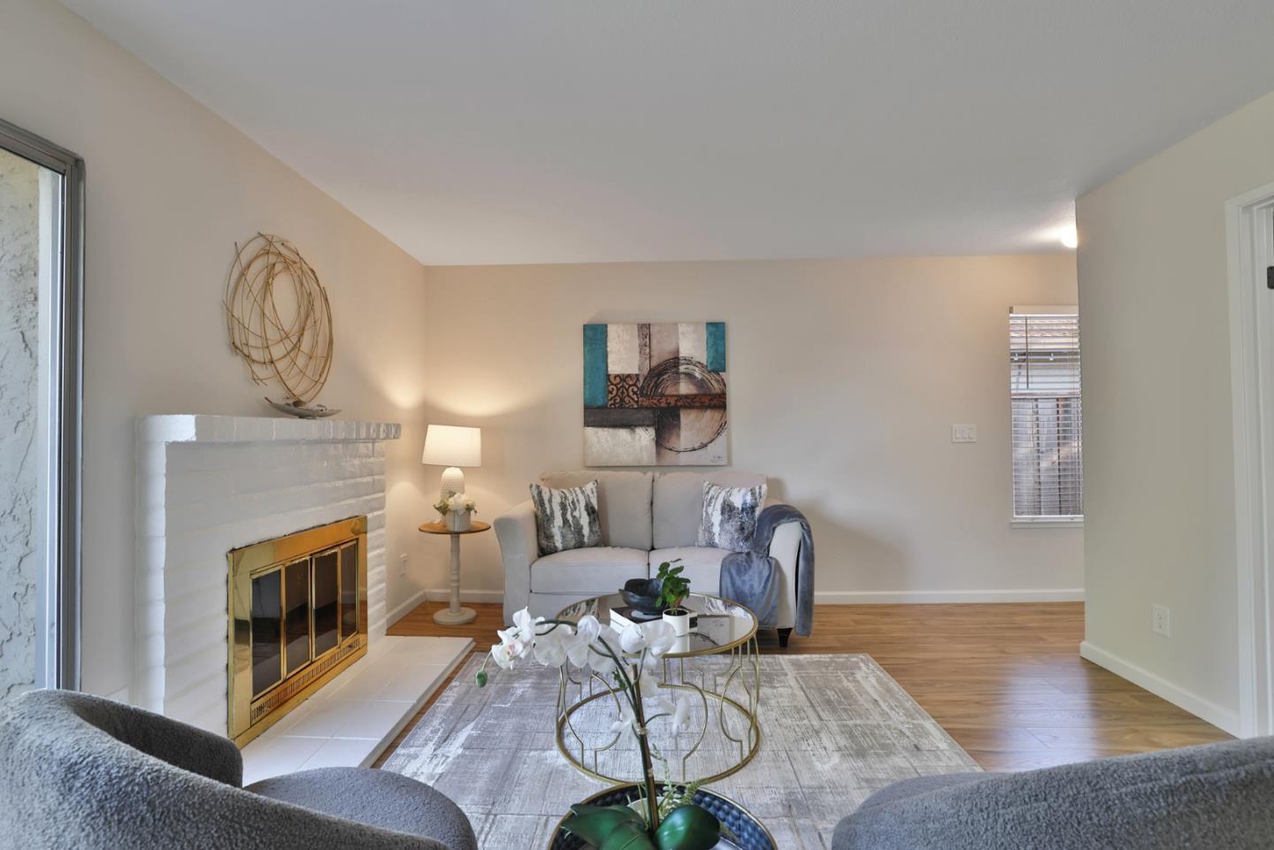 4648 Cherry Avenue San Jose, CA 95118 - Photo 5 of 29 a living room with furniture a fireplace and a chandelier