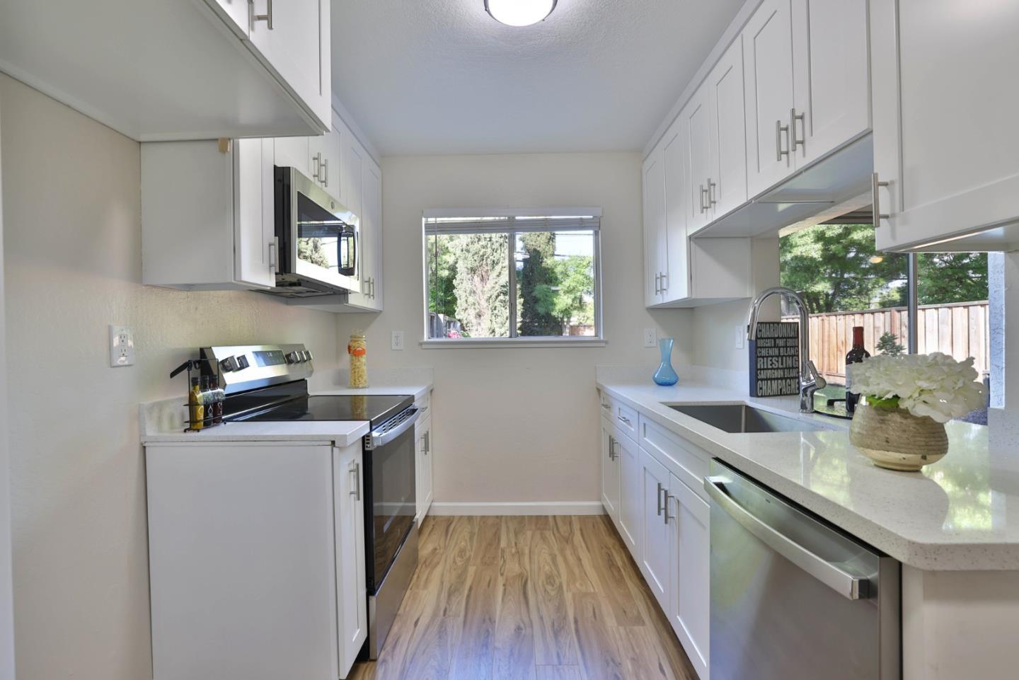 4648 Cherry Avenue San Jose, CA 95118 - Photo 9 of 29 a kitchen with stainless steel appliances granite countertop a sink stove and cabinets