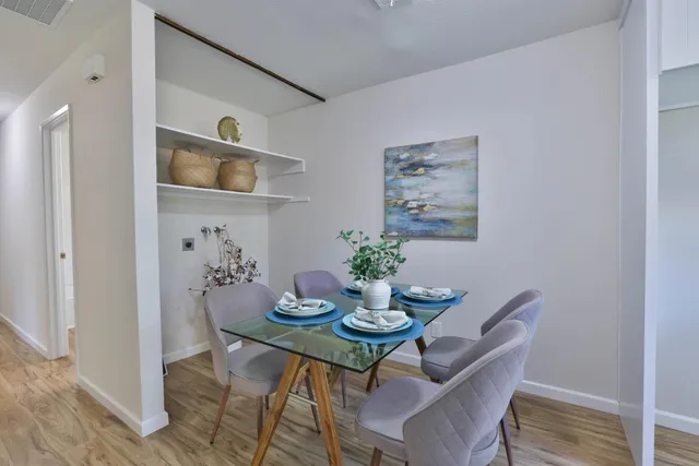 a view of a dining room with furniture and wooden floor