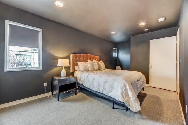 4122 Travis Street, Unit 2 Dallas, TX 75204 - Photo 11 of 19 a bedroom with a bed and a night stand