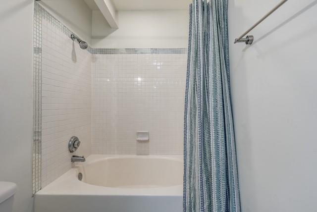 4122 Travis Street, Unit 2 Dallas, TX 75204 - Photo 14 of 19 a bathroom with a bathtub