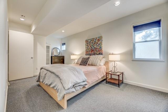 4122 Travis Street, Unit 2 Dallas, TX 75204 - Photo 9 of 19 a bedroom with a bed and a night stand