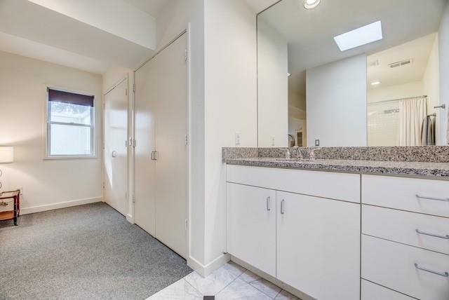 4122 Travis Street, Unit 2 Dallas, TX 75204 - Photo 10 of 19 a bathroom with a granite countertop sink and a mirror