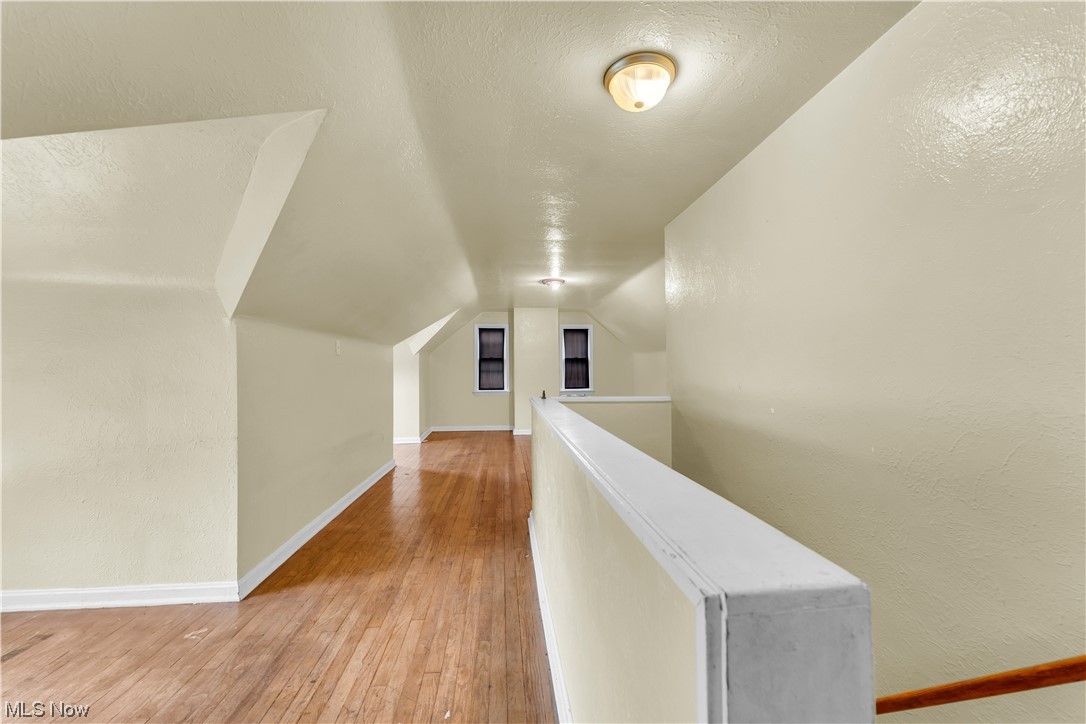 5619 Dunham Road Maple Heights, OH 44137 - Photo 13 of 19 Hallway with a textured ceiling, light hardwood flooring, and lofted ceiling