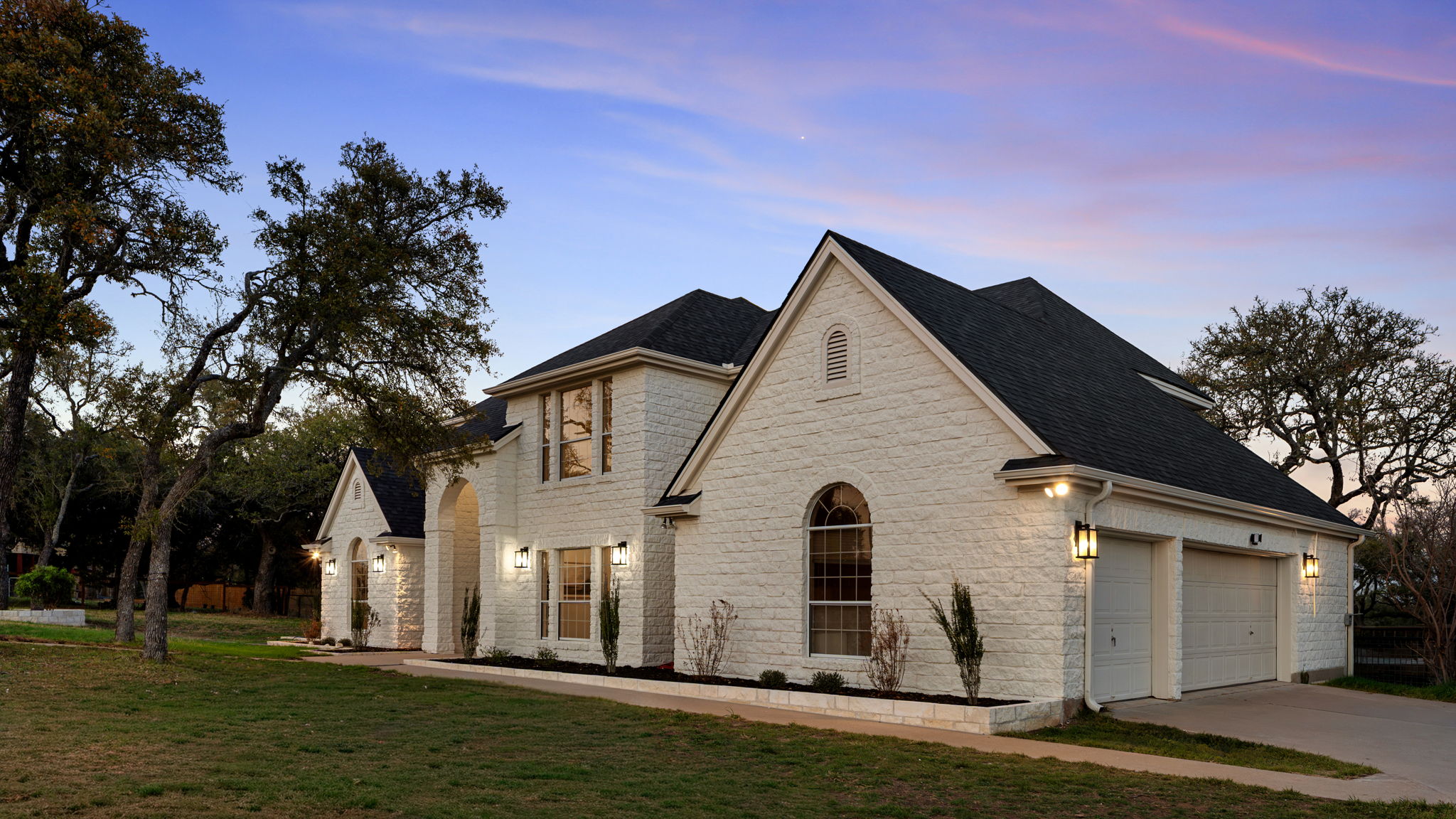 3 Coach House Road Austin, TX 78737 - Photo 4 of 5 a view of a white house next to a yard with big trees